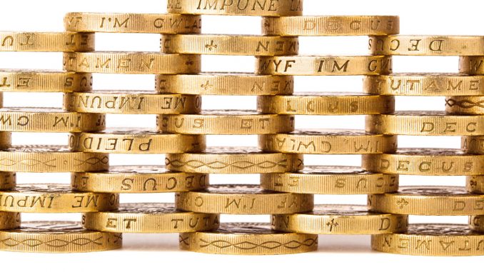 A stack of British pounds symbolizes the 1.2bn debt the Nest Corporation will owe the British Government by 2026.